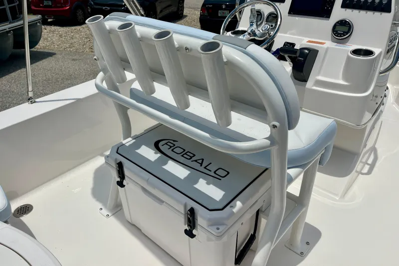 Slide: The Image of 2024 Robalo 206 Cayman boat interior with rod holders and console. - 11