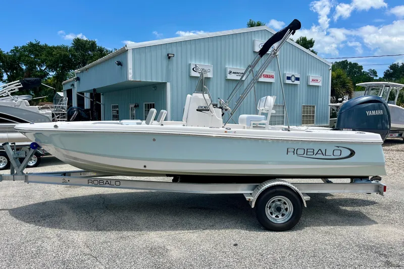 Slide: The Image of 2024 Robalo 206 Cayman boat on trailer, parked outside dealership. - 5