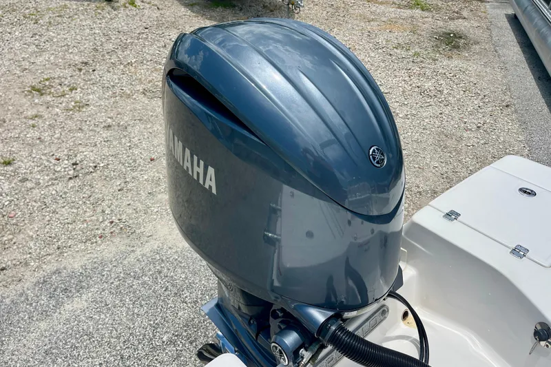 Slide: The Image of Yamaha outboard motor on 2024 Robalo 206 Cayman boat, parked on gravel surface. - 14