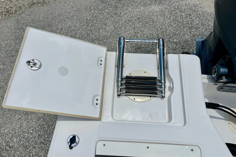 Slide: The Image of 2024 Robalo 206 Cayman boat with open hatch and folded ladder on deck. - 13