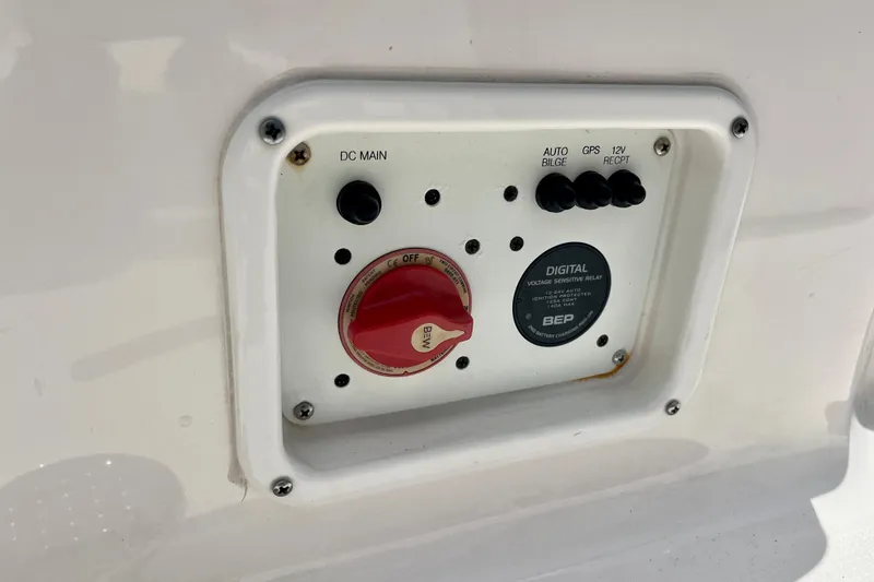 Slide: The Image of Control panel on 2024 Robalo 206 Cayman boat, featuring switches and voltage relay. - 20