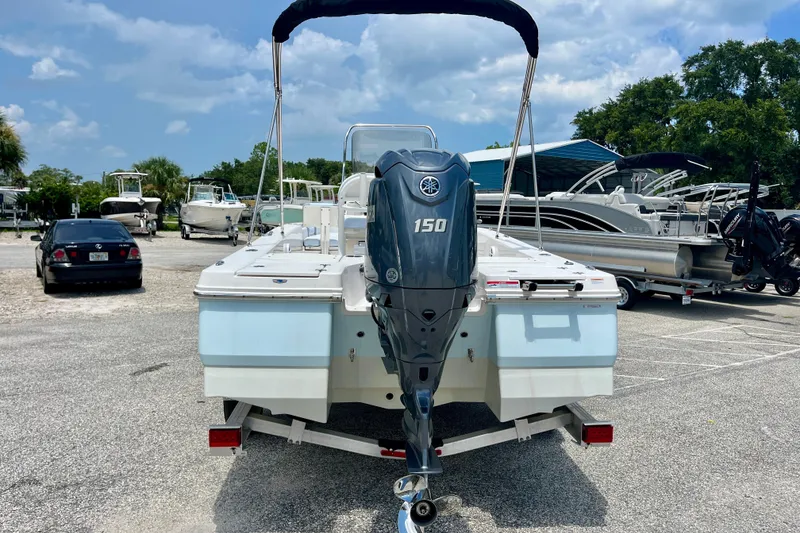 Slide: The Image of 2024 Robalo 206 Cayman boat with Yamaha 150 engine, parked in a marina. - 7