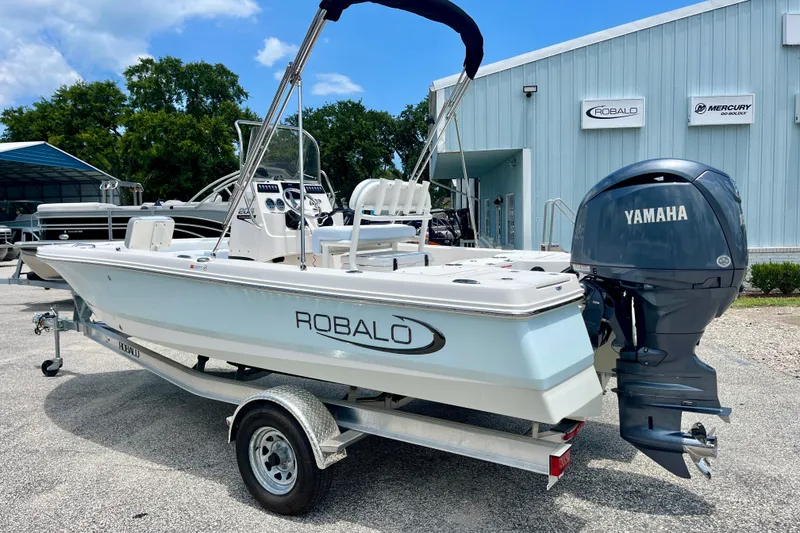 Slide: The Image of 2024 Robalo 206 Cayman boat with Yamaha engine on trailer, parked outside dealership. - 6