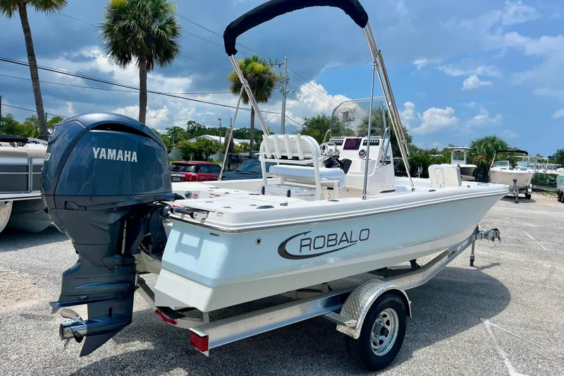 Slide: The Image of 2024 Robalo 206 Cayman boat with Yamaha engine on trailer, parked outdoors. - 8