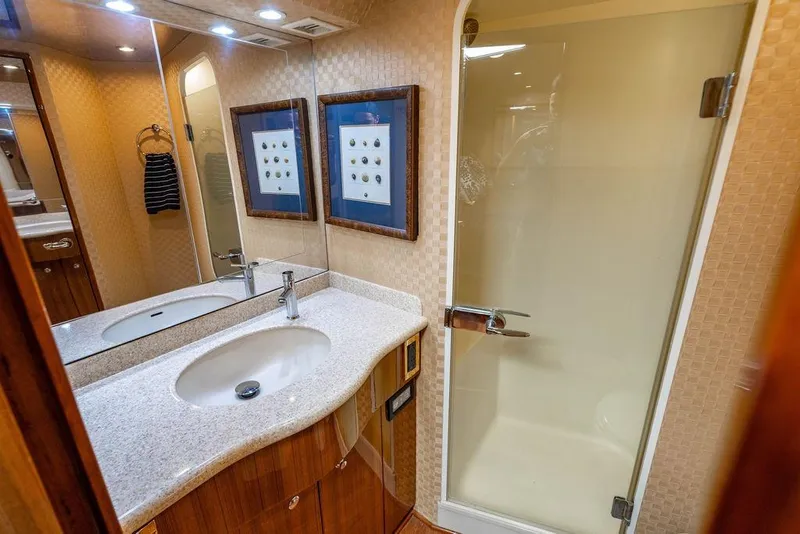 Slide: The Image of Luxurious bathroom in 2006 Viking 56 Convertible yacht with modern fixtures and glass shower. - 25