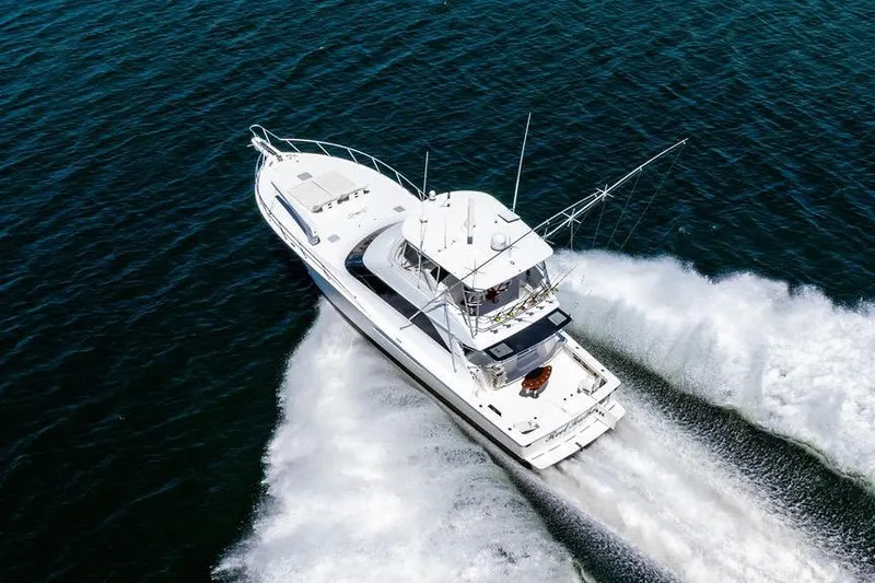 Slide: The Image of 2006 Viking 56 Convertible yacht cruising on open water, aerial view. - 13