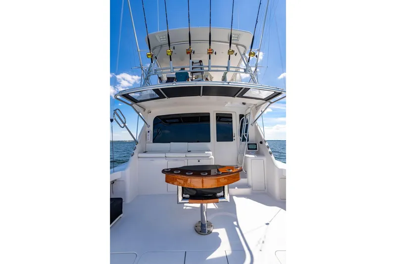 Slide: The Image of 2006 Viking 56 Convertible yacht with fishing rods, ocean view, and sleek design. - 46