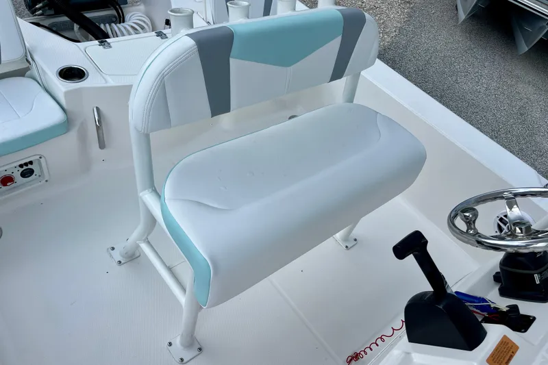 Slide: The Image of 2024 Robalo 206 Cayman boat interior with steering wheel and seating area. - 13