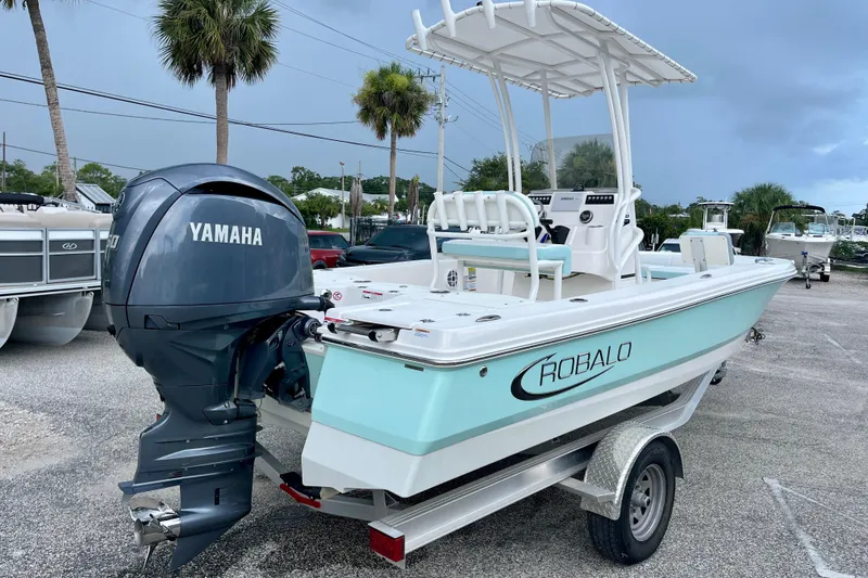 Slide: The Image of 2024 Robalo 206 Cayman boat with Yamaha engine on trailer, parked outdoors. - 8