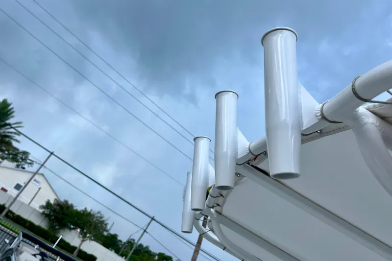 Slide: The Image of 2024 Robalo 206 Cayman boat rod holders against cloudy sky. - 20