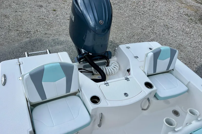 Slide: The Image of 2024 Robalo 206 Cayman boat interior with dual seats and Yamaha outboard motor. - 12