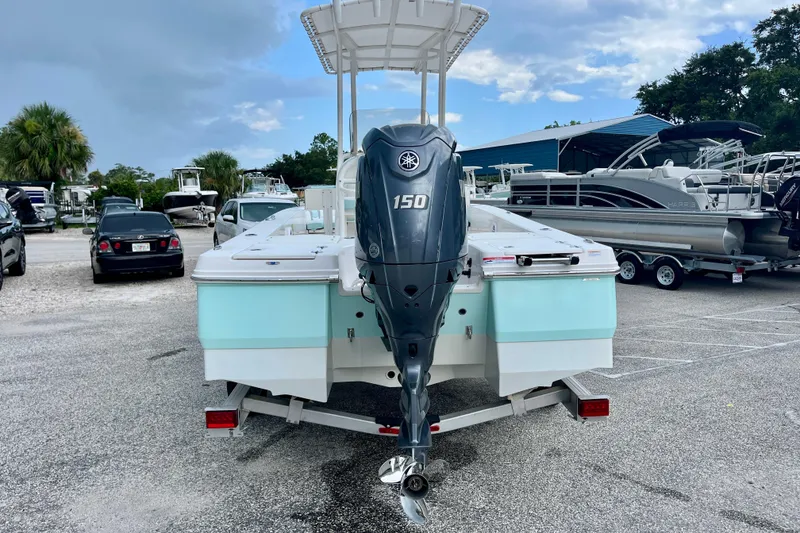 Slide: The Image of 2024 Robalo 206 Cayman boat with Yamaha 150 engine in a marina setting. - 7