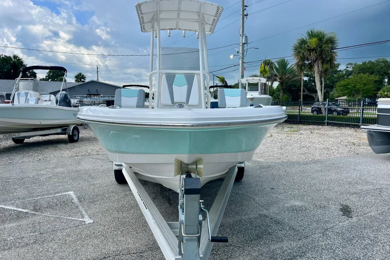 Slide: The Image of 2024 Robalo 206 Cayman boat on trailer, parked outdoors under cloudy sky. - 3