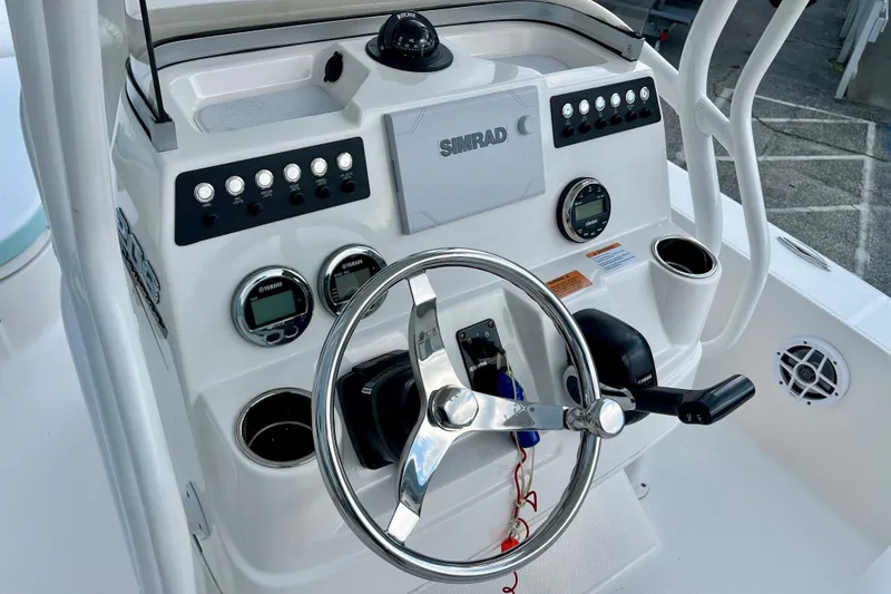 Slide: The Image of 2024 Robalo 206 Cayman boat dashboard with steering wheel and control panel. - 15