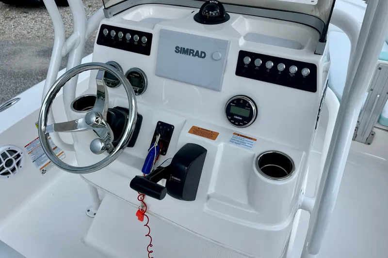 Slide: The Image of 2024 Robalo 206 Cayman boat console with steering wheel and Simrad display. - 14