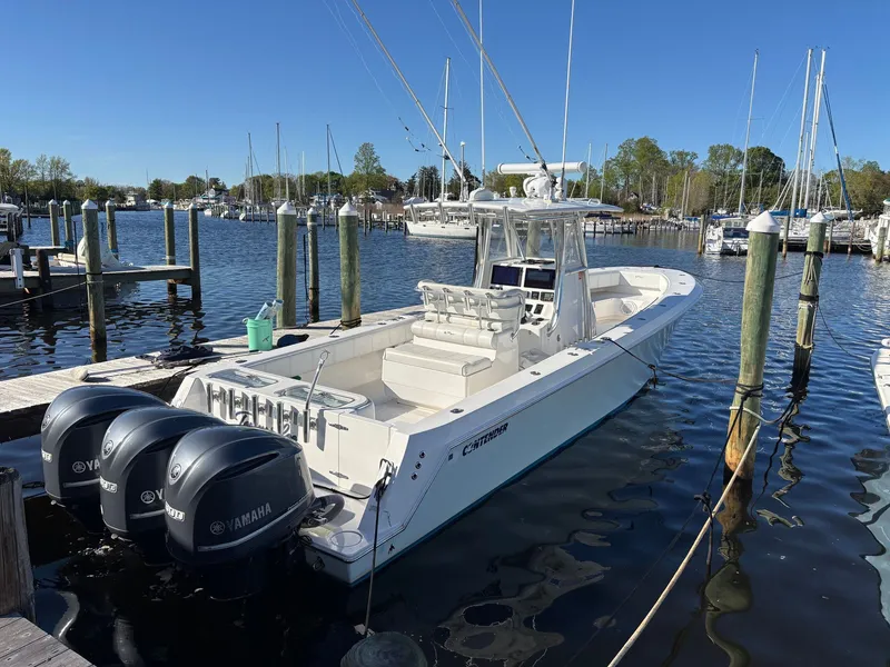 Slide: The Image of A 2015 Contender 35 ST docked. Three Yamaha engines are visible. - 1