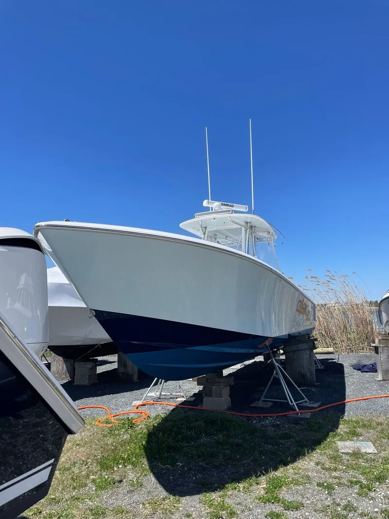 Slide: The Image of A 2015 Contender 35 ST boat is on a stand outdoors under a clear blue sky. - 8