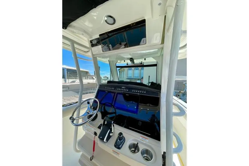 Slide: The Image of 2025 Boston Whaler 330 Outrage helm with advanced navigation controls and sleek design. - 15