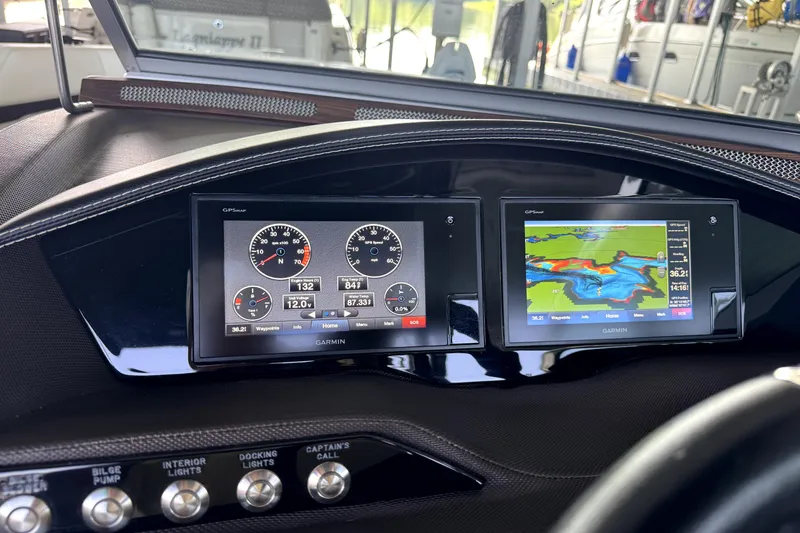 Slide: The Image of Dashboard of a 2019 Cobalt R7 boat featuring Garmin navigation displays. - 12