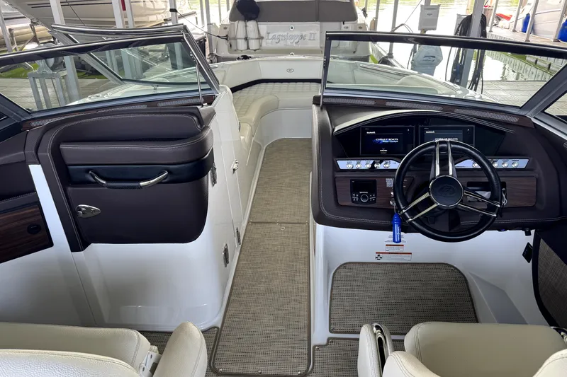 Slide: The Image of Interior view of a 2019 Cobalt R7 boat, featuring a sleek dashboard and steering wheel. - 7
