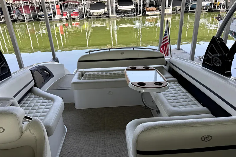 Slide: The Image of Luxurious 2019 Cobalt R7 boat interior with plush seating and table, docked at marina. - 6