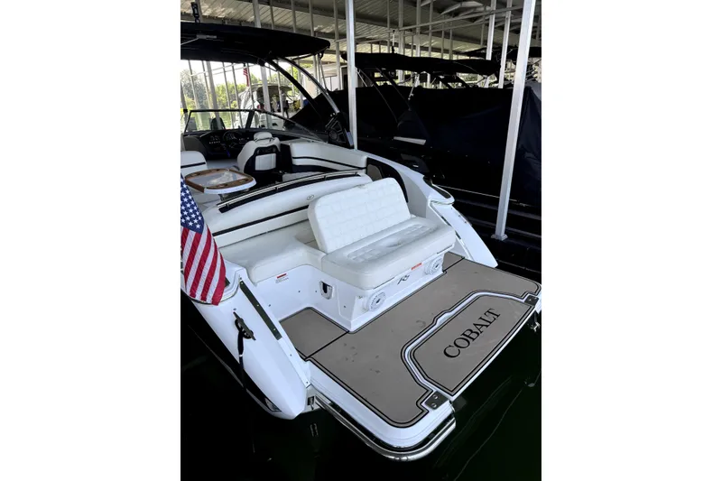 Slide: The Image of 2019 Cobalt R7 boat with American flag, docked in a covered marina. - 4