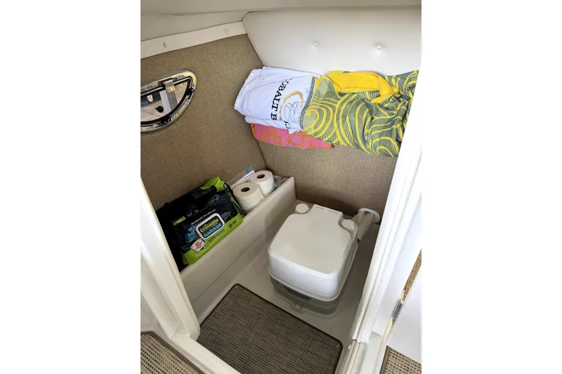 Slide: The Image of 2019 Cobalt R7 boat interior with portable toilet, towels, and cleaning supplies. - 9