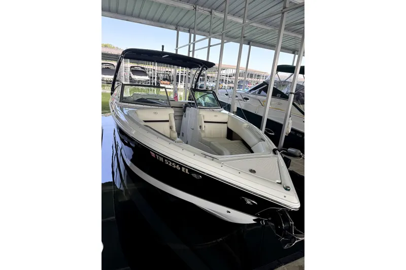Slide: The Image of 2019 Cobalt R7 boat docked under a covered marina. - 11