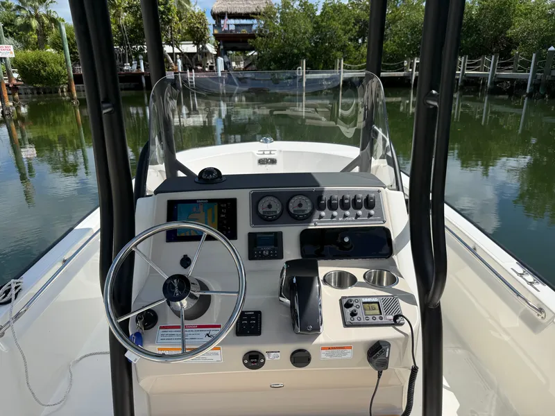 Slide: The Image of The image shows the helm of a Boston Whaler 210 Montauk with modern instruments and a clear view of the water. - 10