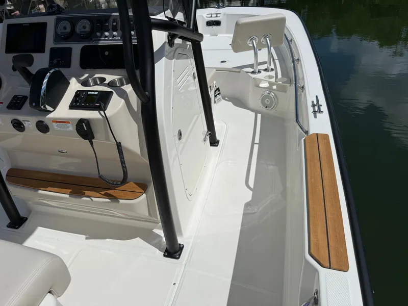 Slide: The Image of The image shows the cockpit of a 2027 Boston Whaler 210 Montauk with modern instruments and wood accents. - 11