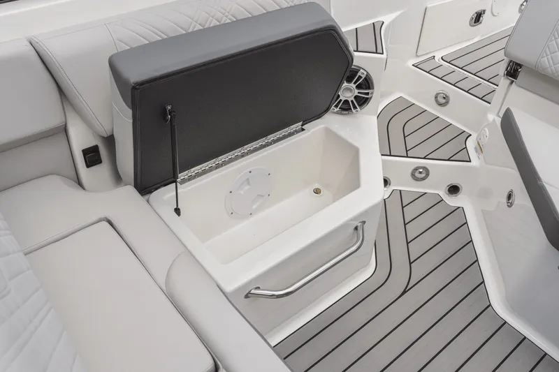 Slide: The Image of The image shows the interior of a 2025 Sea Ray SDX 250 with an open storage compartment. - 85