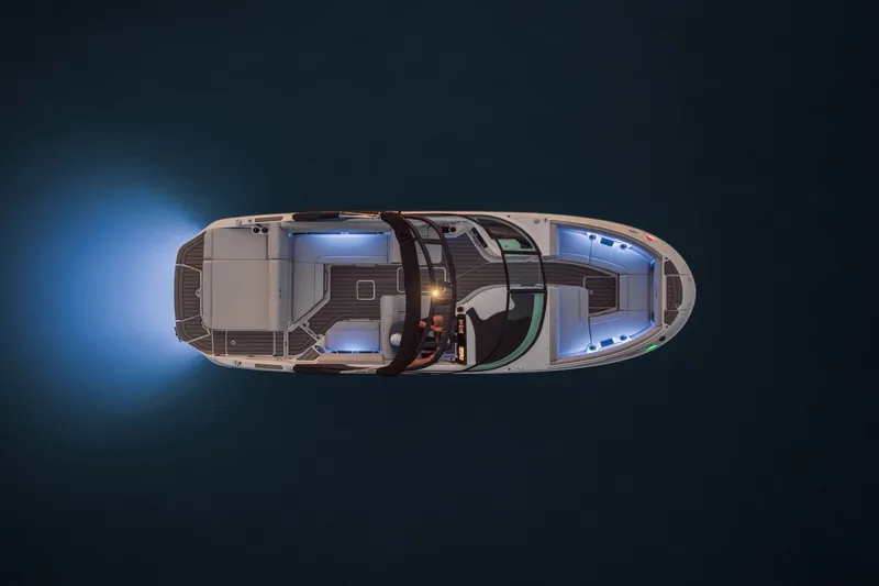 Slide: The Image of Aerial view of a 2025 Sea Ray SDX 250 boat with glowing blue lights on dark water. - 20