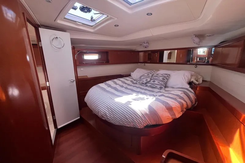 Slide: The Image of Luxurious cabin interior of 2011 Beneteau Oceanis 54 yacht with cozy bed and wooden finish. - 35