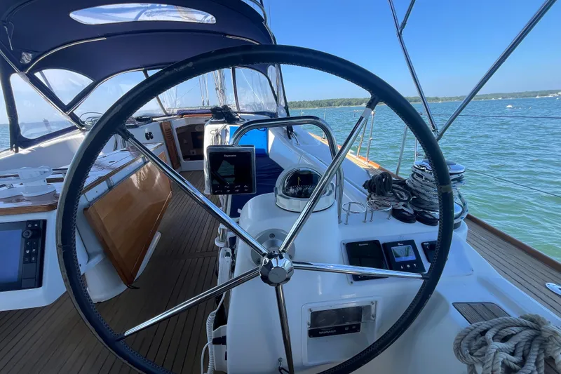 Slide: The Image of Steering wheel of 2011 Beneteau Oceanis 54 yacht with navigation instruments, on calm waters. - 13