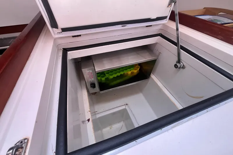 Slide: The Image of Open storage compartment on 2011 Beneteau Oceanis 54 yacht, featuring a built-in cooler. - 32