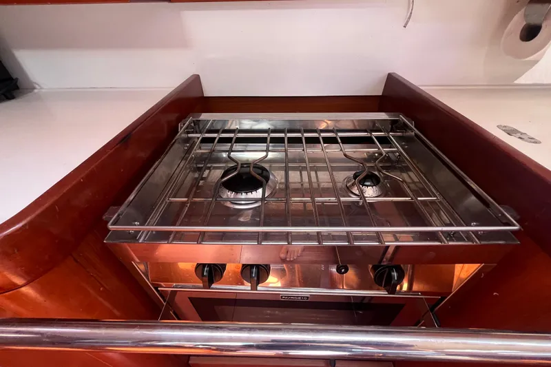 Slide: The Image of Galley stove in 2011 Beneteau Oceanis 54 yacht, featuring dual burners and stainless steel finish. - 31