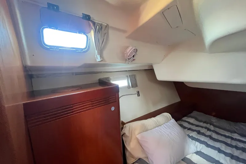 Slide: The Image of Cozy cabin interior of 2011 Beneteau Oceanis 54 with bed and porthole. - 42