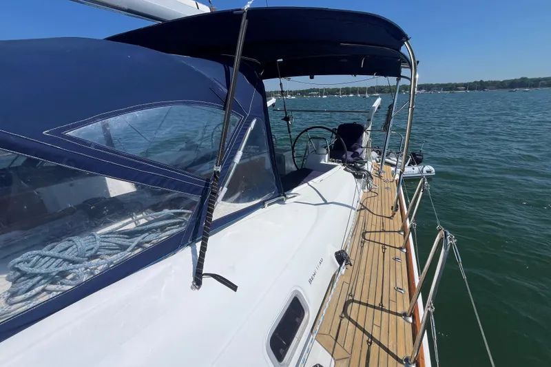 Slide: The Image of 2011 Beneteau Oceanis 54 sailboat with blue canopy on calm water. - 20