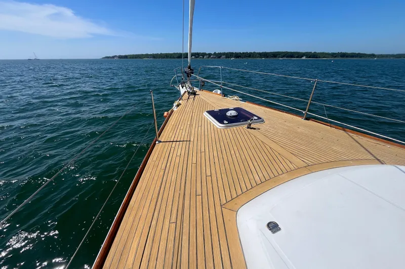 Slide: The Image of Sailing on a 2011 Beneteau Oceanis 54 yacht with teak deck, blue sea, and clear sky. - 6