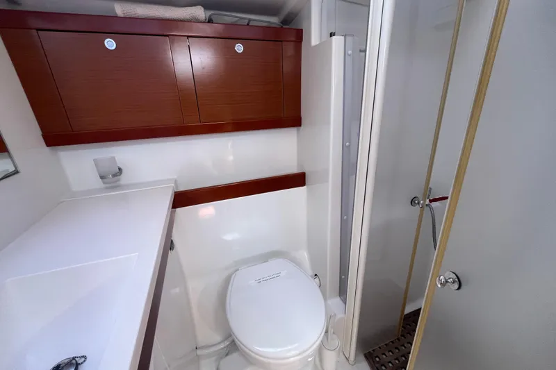 Slide: The Image of Bathroom interior of 2011 Beneteau Oceanis 54 yacht, featuring modern fixtures and wooden cabinetry. - 39