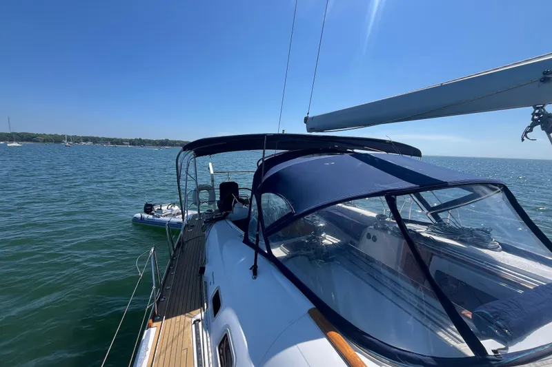 Slide: The Image of 2011 Beneteau Oceanis 54 sailboat on calm waters under clear blue sky. - 21