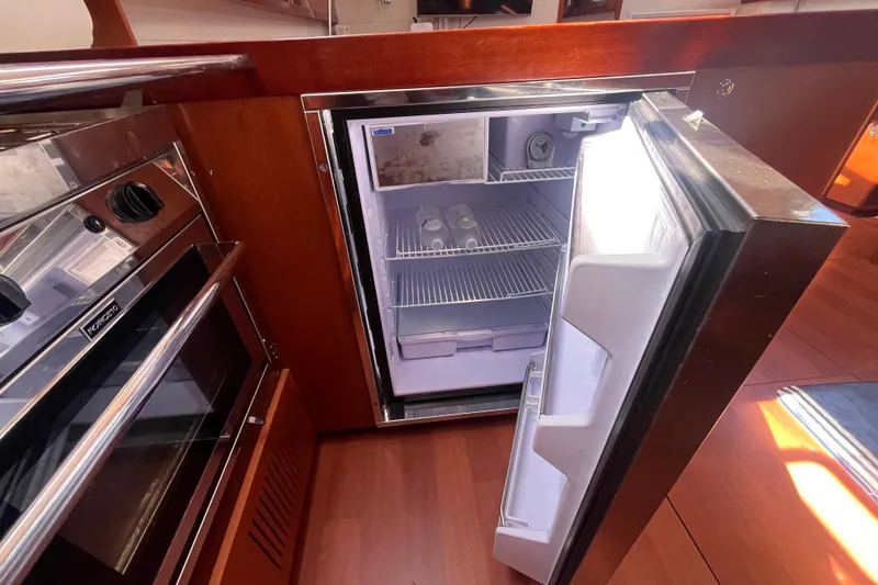 Slide: The Image of Galley of 2011 Beneteau Oceanis 54 with open fridge and oven. - 30