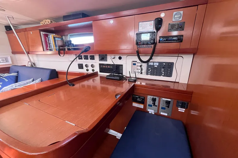 Slide: The Image of Navigation station inside 2011 Beneteau Oceanis 54 yacht, featuring control panels and communication equipment. - 33