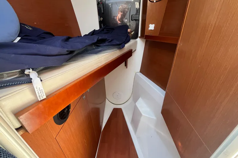 Slide: The Image of Interior cabin of 2011 Beneteau Oceanis 54 yacht, featuring wooden cabinetry and compact design. - 49