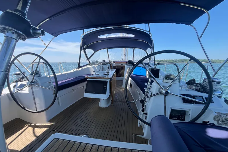 Slide: The Image of 2011 Beneteau Oceanis 54 yacht interior with dual steering wheels and teak deck. - 11