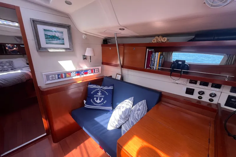 Slide: The Image of Interior of 2011 Beneteau Oceanis 54 yacht with cozy seating and nautical decor. - 28