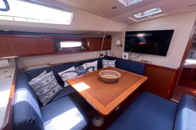 Slide: The Image of Interior of 2011 Beneteau Oceanis 54 yacht with cozy seating and modern decor. - 26