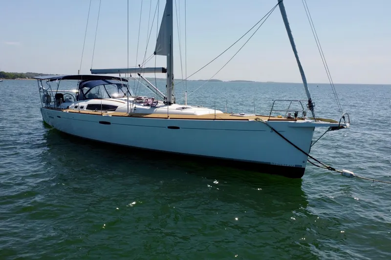 Slide: The Image of 2011 Beneteau Oceanis 54 sailboat anchored on calm waters. - 3