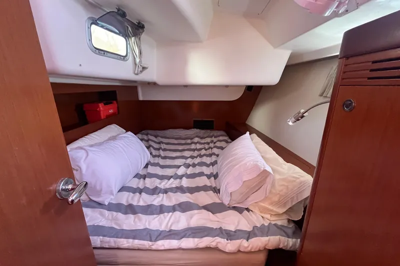 Slide: The Image of Cozy cabin interior of 2011 Beneteau Oceanis 54 sailboat with striped bedding. - 43