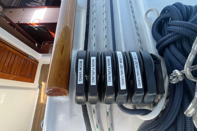 Slide: The Image of Beneteau Oceanis 54 sailboat rigging controls, featuring labeled lines and ropes, 2011 model. - 18